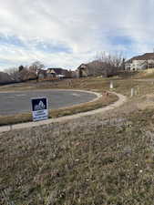 View of asphalt road featuring curbs