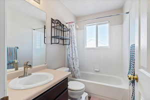 Bathroom featuring vanity and shower / bath combo