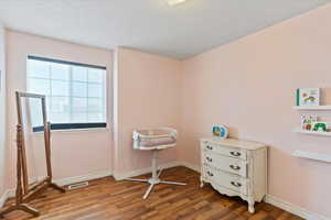 Bedroom featuring light wood-type flooring and a textured ceiling