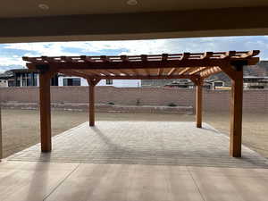 Fenced backyard with a pergola and a patio area