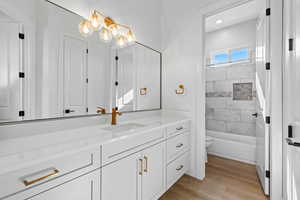 Full bath with vanity, light wood-style flooring, shower / washtub combination, and recessed lighting