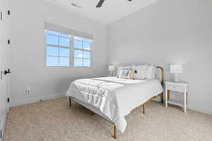Bedroom featuring light carpet and a ceiling fan