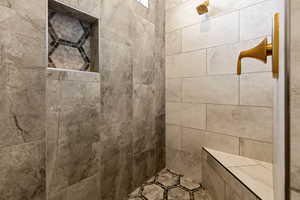 Full bathroom featuring a tile shower