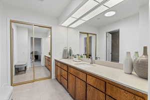 Primary bathroom vanity with second closet