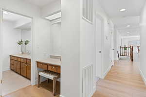 Hallway entry to full bath with exterior vanity