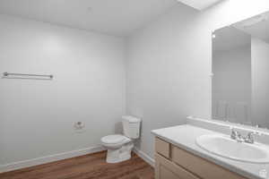 Bathroom featuring vanity, dark wood-style flooring, and a shower