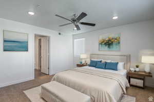 Carpeted bedroom featuring ceiling fan and recessed lighting