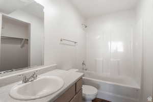 Full bath featuring vanity and shower / bath combination