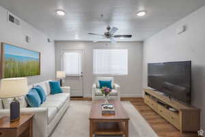 Living room with wood finished floors and a ceiling fan