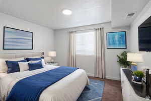 Bedroom featuring dark carpet and baseboards