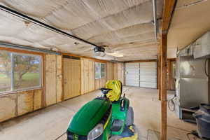 Garage featuring heating unit and a garage door opener