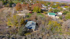 Aerial view of property and surrounding area with nearby suburban area