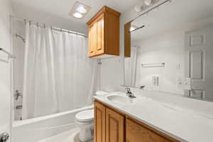 Bathroom featuring vanity and shower / bath combo with shower curtain