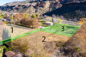 Aerial view of property's location featuring a mountainous background and property parcel outlined