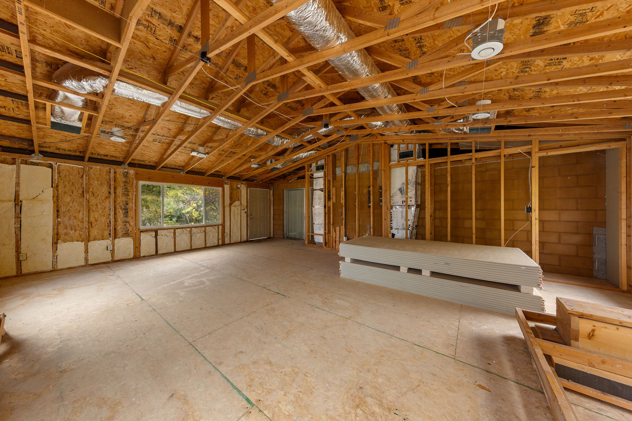 Misc room featuring lofted ceiling and a garage