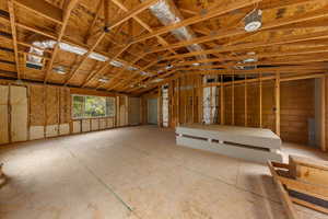 Misc room featuring lofted ceiling and a garage