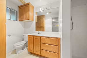 Full bath featuring vanity and tiled shower