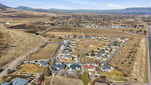 Aerial overview of property's location featuring nearby suburban area and mountains