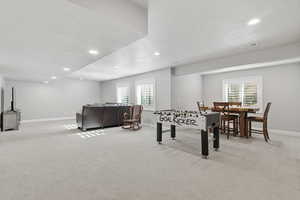 Rec room featuring light colored carpet, recessed lighting, and a textured ceiling