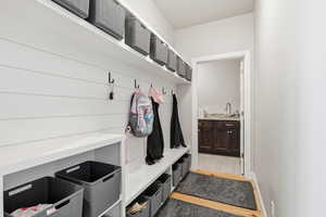Mudroom featuring a sink and light wood finished floors