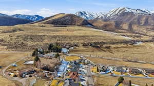 View of mountain backdrop featuring nearby suburban area