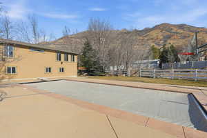 View of swimming pool featuring a mountain view and a diving board