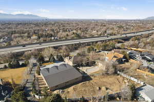 Aerial view of property and surrounding area with nearby suburban area and a mountain backdrop