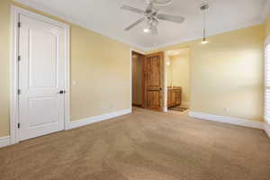 Unfurnished bedroom with carpet flooring, ornamental molding, a ceiling fan, connected bathroom, and recessed lighting