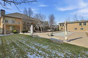 View of green lawn featuring a pergola, a patio, and a balcony