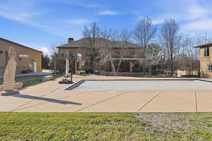 View of swimming pool with a balcony