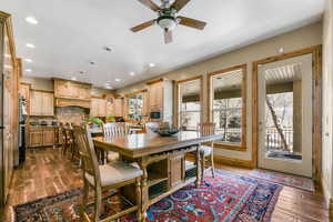 Dining space featuring dark wood-style flooring, ceiling fan, and recessed lighting