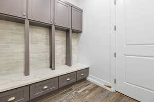 Mudroom with dark wood-style floors and baseboards