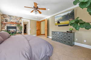Bedroom with crown molding, a fireplace, ceiling fan, carpet, and recessed lighting