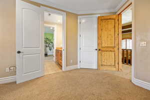 Unfurnished bedroom with light colored carpet and ensuite bath