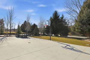 View of sport court with community basketball court and a yard