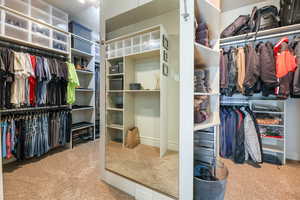 Walk in closet featuring light carpet