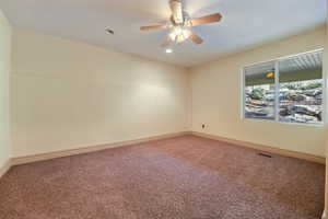 Carpeted empty room with ceiling fan and recessed lighting