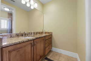 Full bathroom with vanity, a shower with curtain, and light tile patterned floors