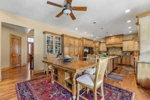 Dining room featuring light wood-style flooring, ceiling fan, and recessed lighting