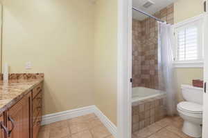 Full bath featuring vanity and tiled shower / bath