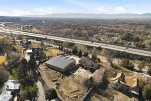 Aerial view of property's location featuring nearby suburban area and a mountain backdrop
