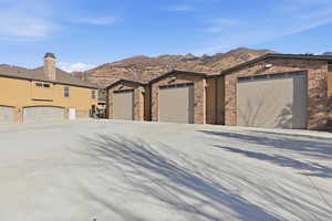 Prairie-style house with driveway, stucco siding, and stone siding