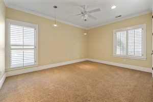 Unfurnished room featuring light carpet, ornamental molding, ceiling fan, and recessed lighting