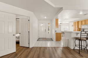 Foyer entrance featuring a textured ceiling, light wood finished floors, and recessed lighting