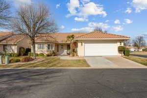 Ranch-style home featuring stucco siding, concrete driveway, covered porch, and a tiled roof
