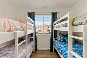 Bedroom featuring light wood-type flooring and baseboards