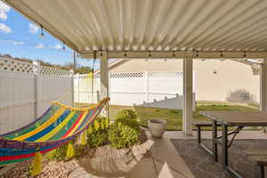 Fenced backyard with a patio area and outdoor dining space