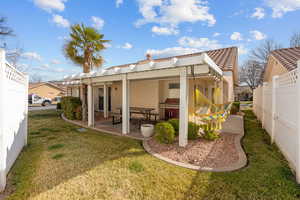 Back of property featuring a tiled roof and a patio area