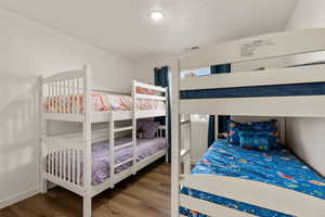 Bedroom with wood finished floors and baseboards