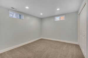 Below grade area featuring light carpet and recessed lighting